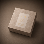 The ZEYN Case refillable fragrance device box with gold foil label on textured taupe background