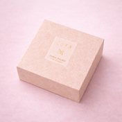 ZEYN Zuria Pudra Signature Set box with delicate patterned design placed on a warm textured surface.