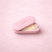 Open pink ZEYN perfume balm device showing the solid Zuria fragrance pod inside.