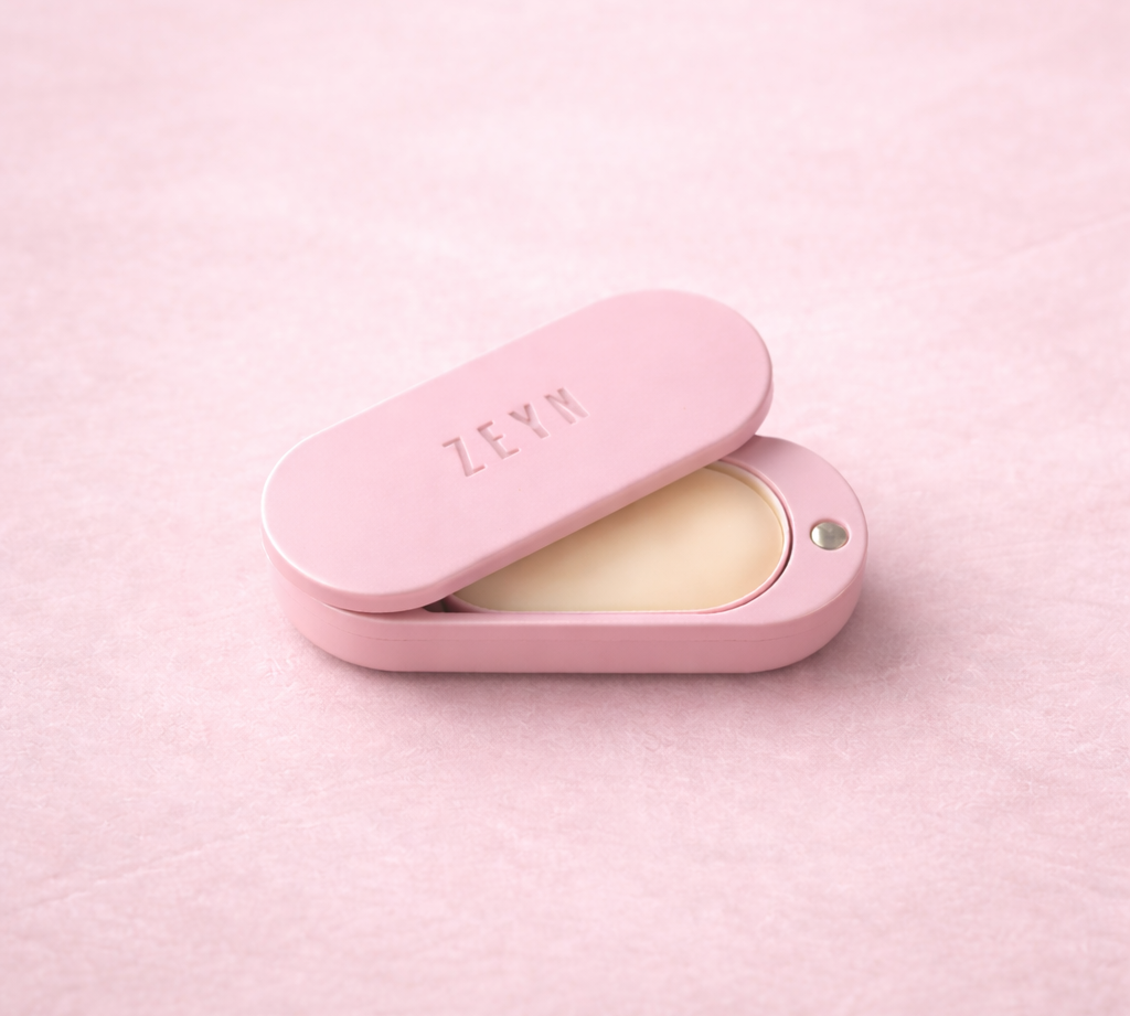Open pink ZEYN perfume balm device showing the solid Zuria fragrance pod inside.